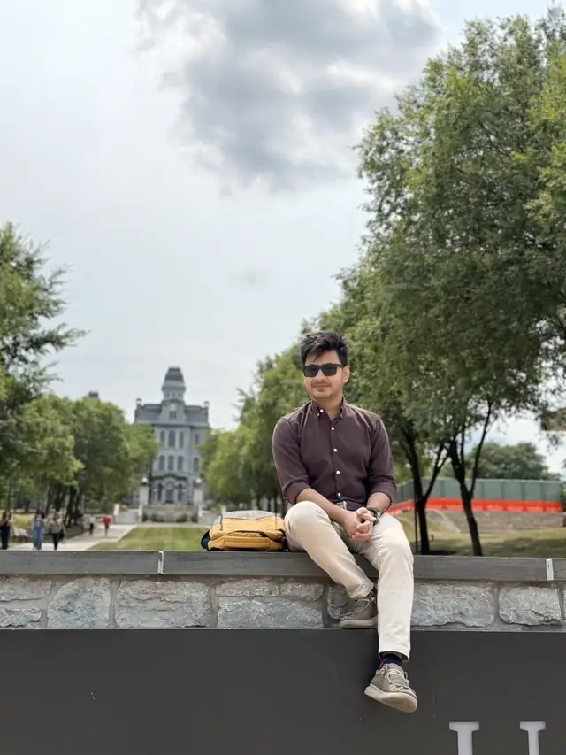 Naim Bin Hasan on the Syracuse University campus, with the Hall of Languages in the background.